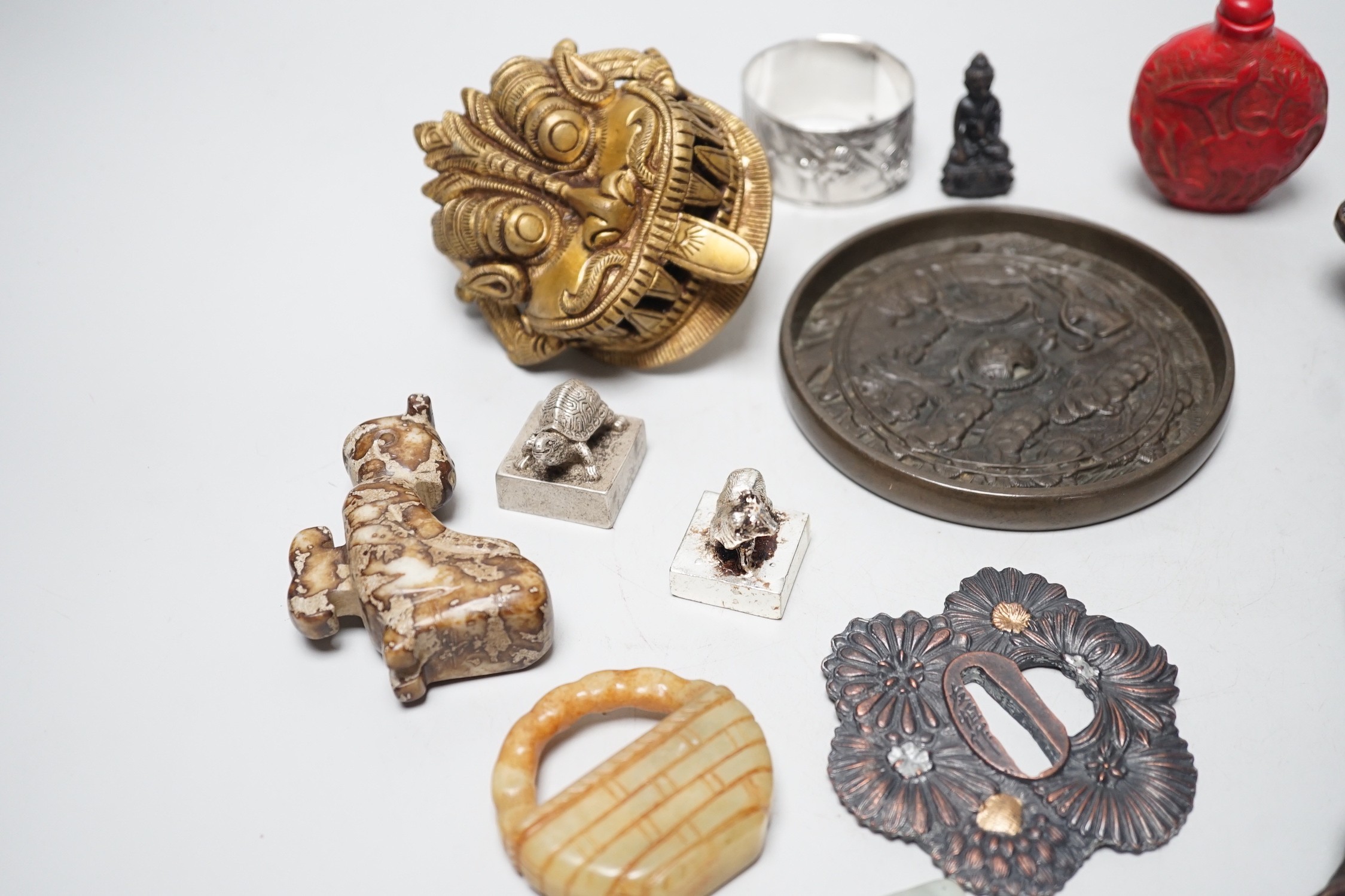 A selection of various Oriental items, including Chinese hardstone carvings, Japanese cast bronze mirror, snuff bottle, Japanese napkin ring etc.